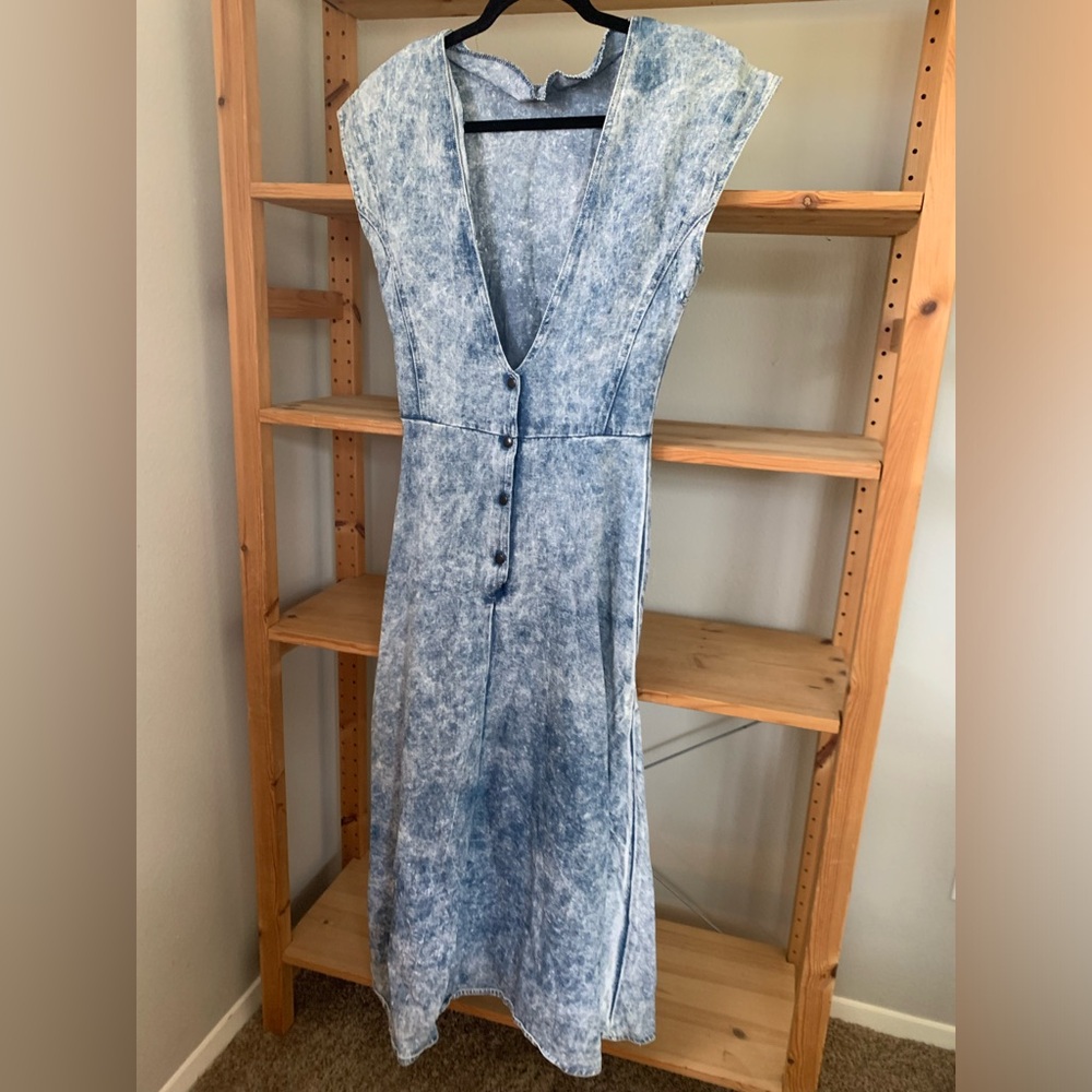 Distressed Denim Dress with Deep V and Back pockets.